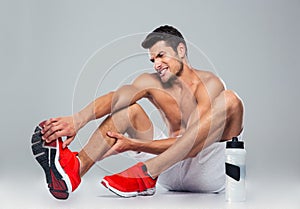 Portrait of a fitness man with foot pain