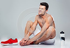 Portrait of a fitness man with foot pain