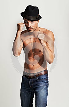 Portrait, fitness model and man shirtless, boxing and muscular results from strength training, fight gesture and workout
