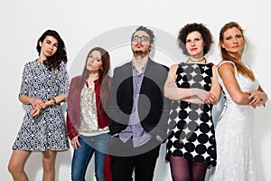 Portrait of five people standing on white background