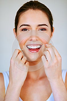 Portrait, flossing teeth and happy woman cleaning mouth in home bathroom for health, wellness and morning routine. Face