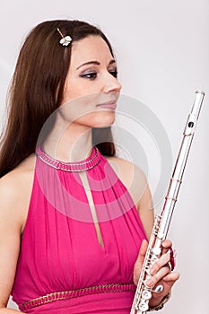 Portrait of flutist woman in red dress with flute photo