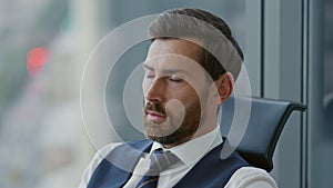 Portrait focused bearded businessman reading unsatisfactory news on smartphone.