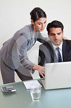 Portrait of a focused business team working with a laptop