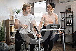 Portrait of focused caucasian male and african female wearing sportswear