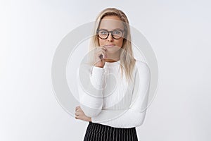 Portrait of focused and serious-looking female entrepreneur working thinking about interesting and risky offer touching