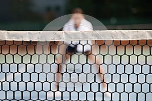 Portrait of forceful woman playing tennis on outdoor tennis court