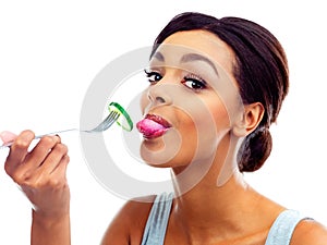 Portrait, fork and woman with cucumber, nutrition and sustainable eating to lose weight in studio. Vegetable, salad and