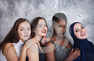 Portrait of four girls with different skin color and nationality in the studio