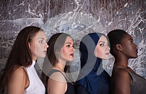 Portrait of four girls with different skin color and nationality in the studio