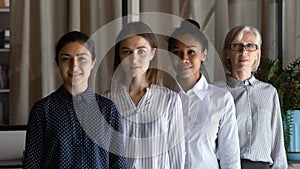 Portrait of four multiethnic business women older and younger generations