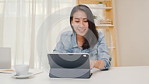 Portrait of freelance smart business women casual wear using tablet working in workplace in living room at home. Happy young Asian