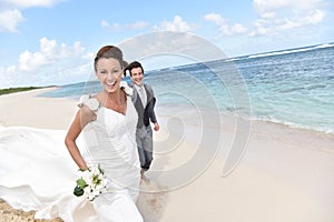 Portrait of freshly married couple on the beach feeling happy