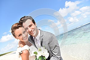 Portrait of freshly married couple on caribbean beach