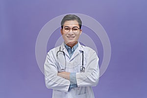 portrait of friendly Asian doctor man over purple smiling to camera