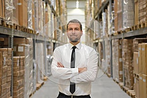 portrait friendly businessman manager in suit working in the warehouse of a company