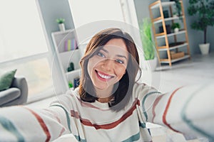 Portrait of friendly cheerful girl toothy smile make selfie recording video modern spacious house inside