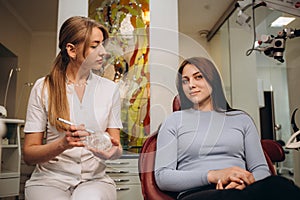 Portrait of friendly female doctor and patient at dentist's office