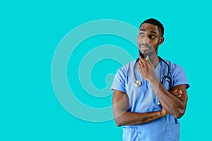 Portrait of a friendly male doctor or nurse wearing blue scrubs uniform