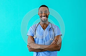 Portrait of a friendly male doctor or nurse wearing blue scrubs uniform and stethoscope