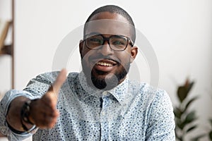 Portrait of friendly smiling African businessman offering hand for greeting