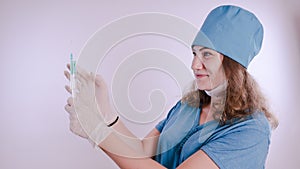 Portrait of a friendly smiling doctor woman or nurse in white medical uniform with a syringe, on white background with co