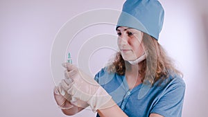 Portrait of a friendly smiling doctor woman or nurse in white medical uniform with a syringe, on white background with co