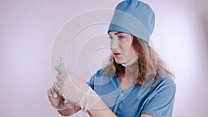 Portrait of a friendly smiling doctor woman or nurse in white medical uniform with a syringe, isolated on white background with co