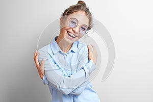 Portrait friendly smiling Kazakh Asian girl joyfully hugs herself and laughs on a white background 