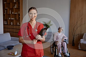Portrait of friendly smiling woman doctor or nurse at nursing home