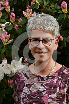 Portrait of a friendly woman standing in her garden