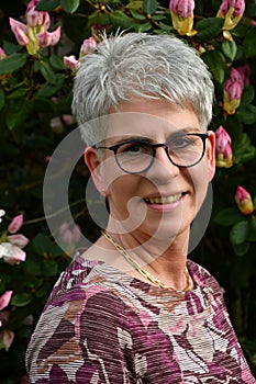 Portrait of a friendly woman standing in her garden