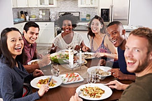 Portrait Of Friends Enjoying Dinner Party At Home