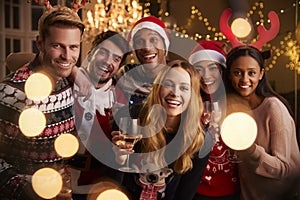 Portrait Of Friends In Festive Jumpers At Christmas Party
