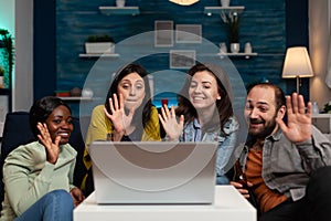 Portrait of friends greeting remote collegue during online videocall meeting