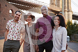 Portrait Of Friends Walking By Brooklyn Bridge In New York City