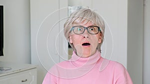Portrait of a frightened and calmed middle-aged woman with glasses. Close-up, emotion concept.Human expressions of fear.