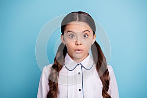 Portrait of frightened child stare stupor wear white blouse isolated over blue background