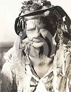 Portrait of frowning woman wearing torn hat