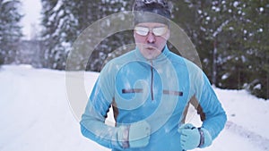 Portrait frozen sports athlete man, portrait of an athlete in winter, running in a cold time,winter sports