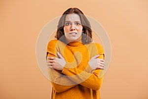 Portrait of a frozen young woman in sweater