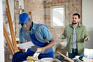 Portrait of frustrated builder holding dismissal letter