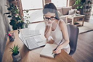 Portrait of frustrated girl ceo copy writer sit chair desk work remote write copybook project have no idea hold pencil