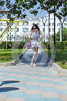 Portrait in full growth, beautiful young woman in white dress