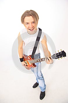 Portrait in full growth.a young guy with a guitar