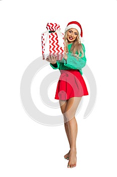 Portrait of full length beautiful woman in santa hat with toothy smiley face, white background with copy space, studio shot,