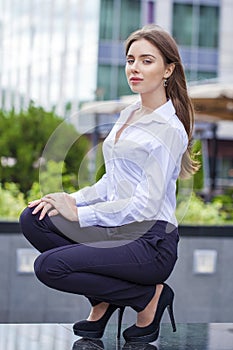 Portrait in full length, young business woman in white shirt