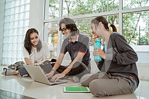 Portrait fun students sit down working in groups