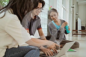 Portrait fun students sit down working in groups