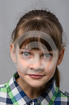 Portrait of a fun surprised ten year old girl of European appearance, close-up